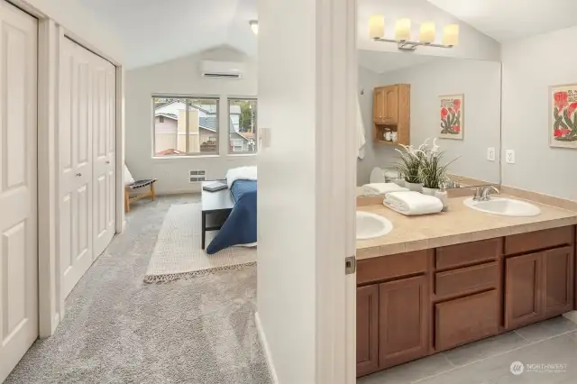 Your primary suite boasts a full bathroom with dual sinks, plus a wall of closet space