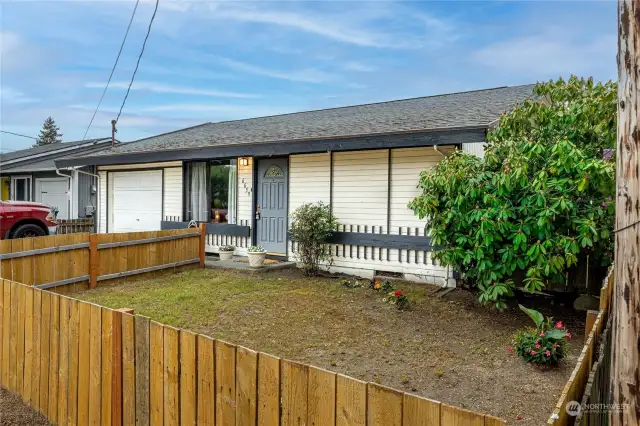 Partially fenced front yard. What will you do with this blank slate? A rose garden, a vegetable garden, install a water feature? Your choice.