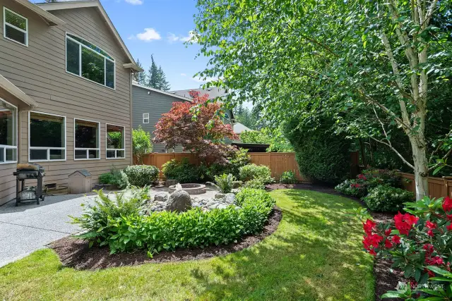 Very private setting with gorgeous landscaping! Flagstone walkway and seating area, gas firepit and beautiful, tranquil water feature.