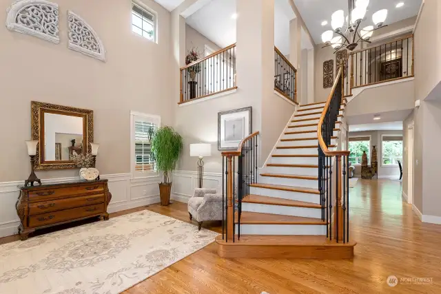 Formal living room and main staircase with gorgeous hardwood floors on the main level and staircase. Tech/Loft area over looks the livng room and entry.