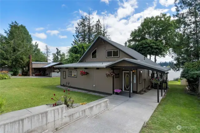 Covered front porch welcomes you in! The walkway continues to a side deck with additional entrance to the family room.