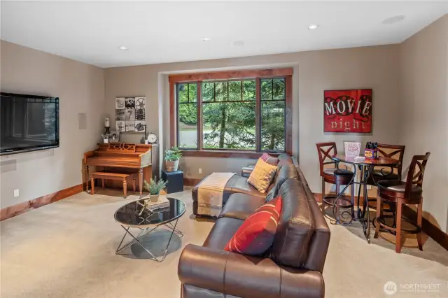 Beyond the kitchen is the Home Theater Room. This space is complete with a 7:2 surround sound system. To the right is a large Media closet which houses the whole-home sound system, plus the surveillance camera / security monitoring system.