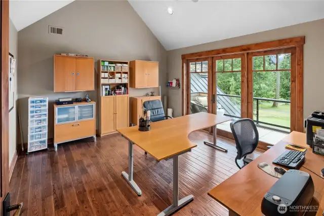 Whether you work from home, have craft hobbies, or would just like additional private space, this 2nd office features vaulted ceilings and a wall of windows to a deck overlooking the course.