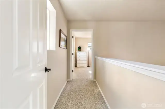Walkway toward bedroom off of the upstairs media room. Would be an exceptional  space for an office, homeschool, home gym, craft or hobby!