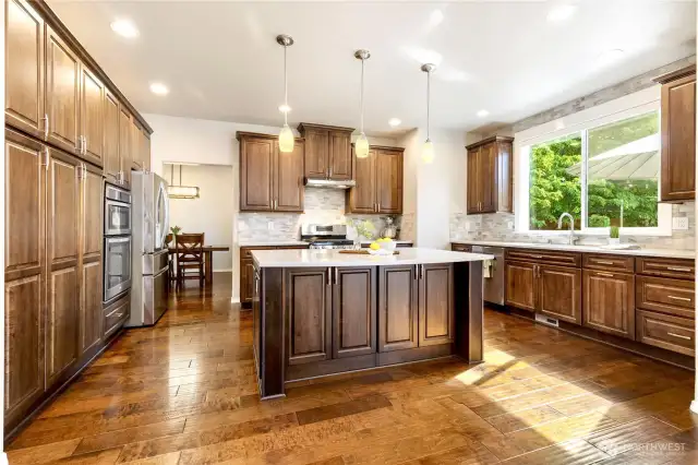 Custom wood cabinetry with ample storage and island seating!