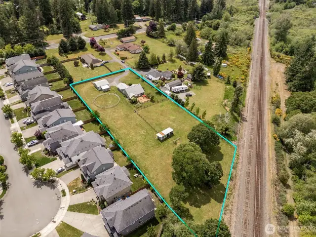 Quiet meets convenience. A green buffer and train tracks keep your backyard calm, while the friendly cul-de-sac neighborhood next door adds just the right amount of community.