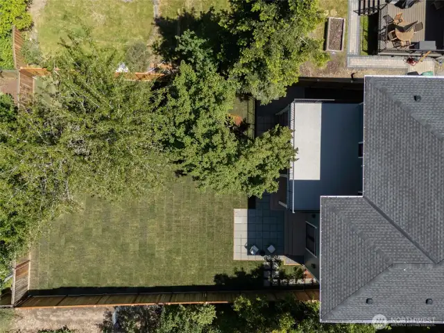 Epic huge level grassy and fenced backyard, directly off the kitchen and main floor living room.