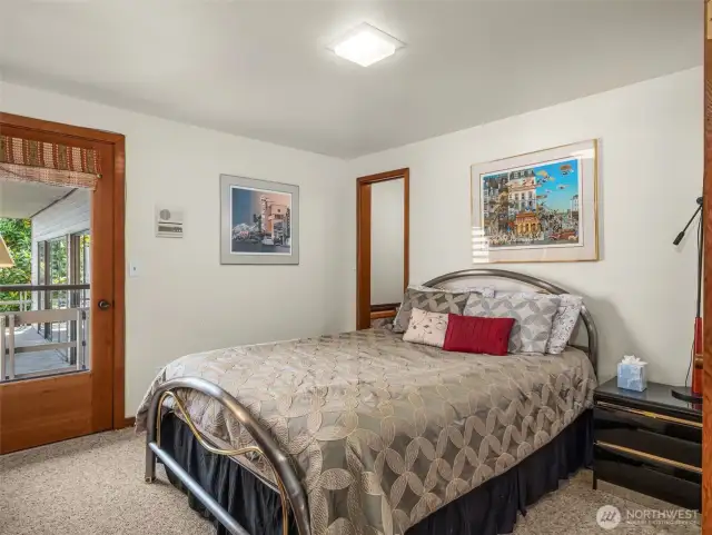 Main level bedroom with door out to view deck.