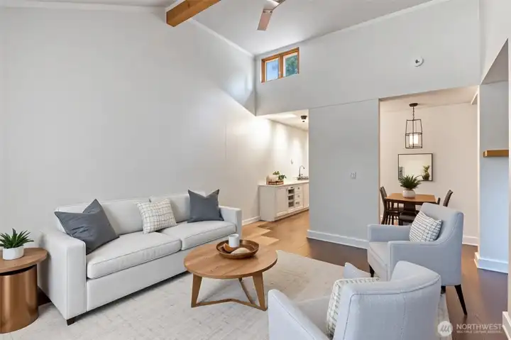 Virtually staged. Living room with vaulted ceiling creates an airy, open feel.