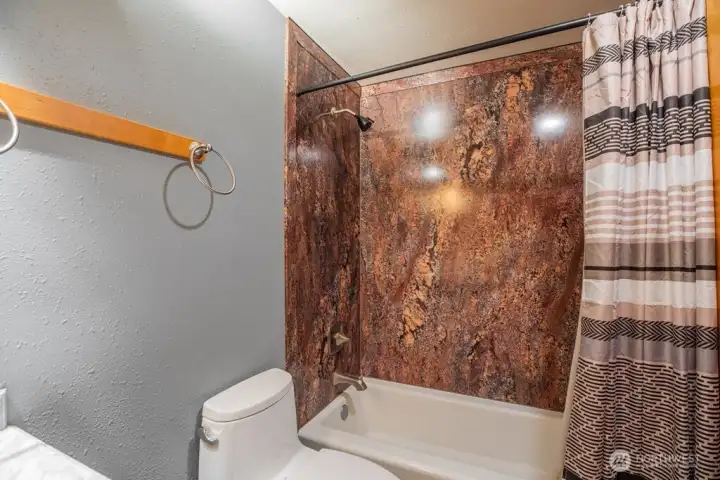 Full bath with tub/shower combo.