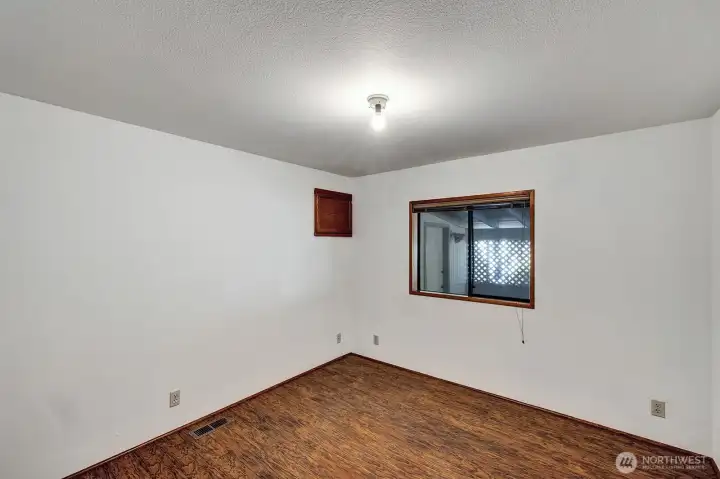 Guest bedroom on East side of the home has window view to carport area.