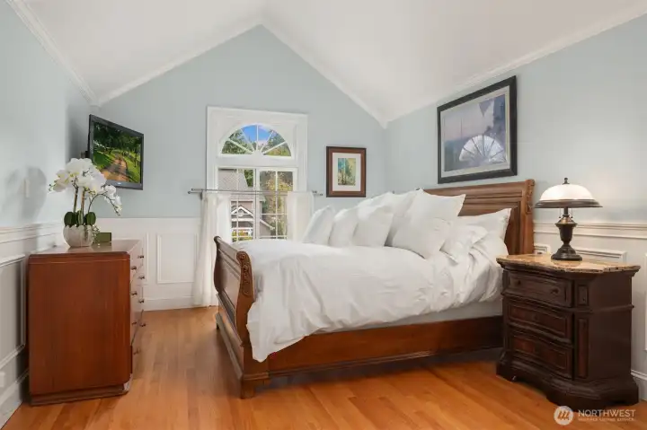 Primary Suite with shiny Swedish flooring, vaulted ceilings, customized closet with jewelry drawer, and built-ins.