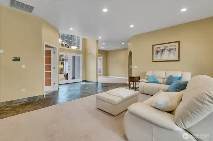 View from the living area looking toward the entry, with the dining area positioned just off to the right.