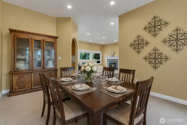 Dining area overlooking the living area, highlighting an open and inviting layout perfect for everyday living and entertaining - virtually staged to showcase its full potential.