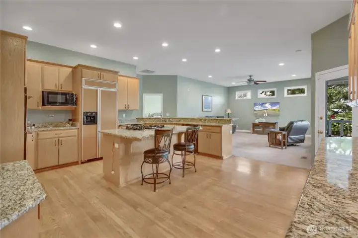 The open kitchen and family room is bright, open, and filled with natural light, creating a warm and welcoming space for everyday living and entertaining.