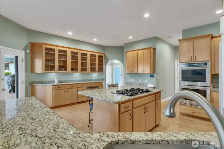 The kitchen is enhanced with additional counter space and cabinetry, providing the perfect setup for both functionality and stylish display.
