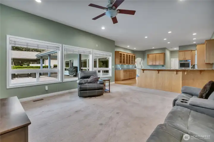 View from the family room into the kitchen, with access to the backyard view deck, highlighting the home’s open flow and inviting outdoor living space.