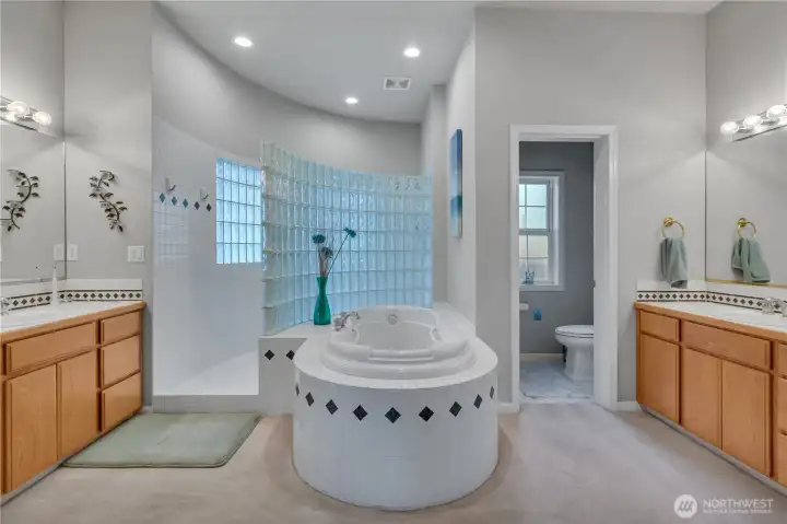 His-and-hers vanities and a separate water closet add comfort, convenience, and functionality to the primary ensuite.