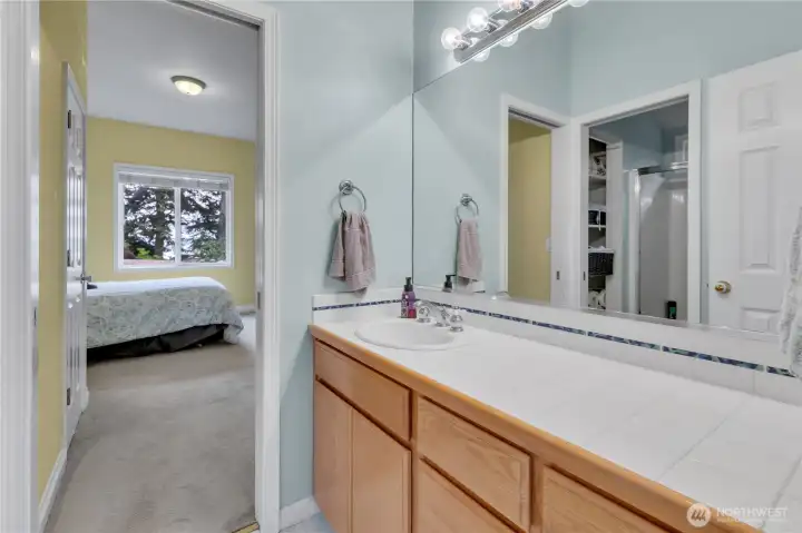 The Jack & Jill bath offers generous counter space and a separate shower area, providing comfort and convenience for overnight guests.