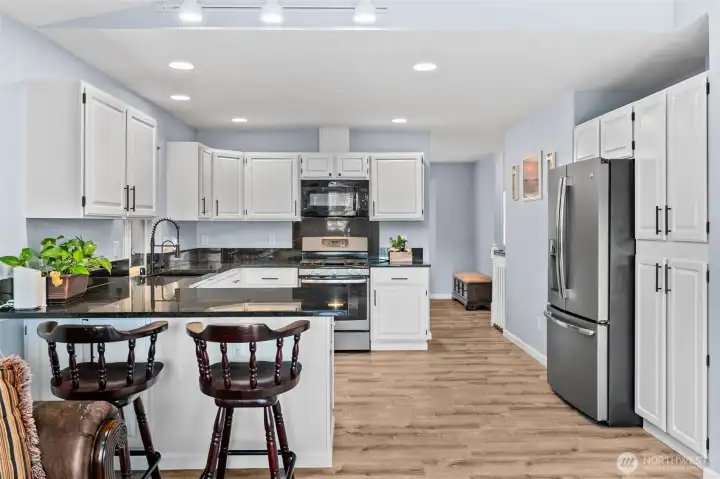 Cozy on up to the eat-in bar at the kitchen counter. Notice the fabulous kitchen storage & great recessed & track lighting!