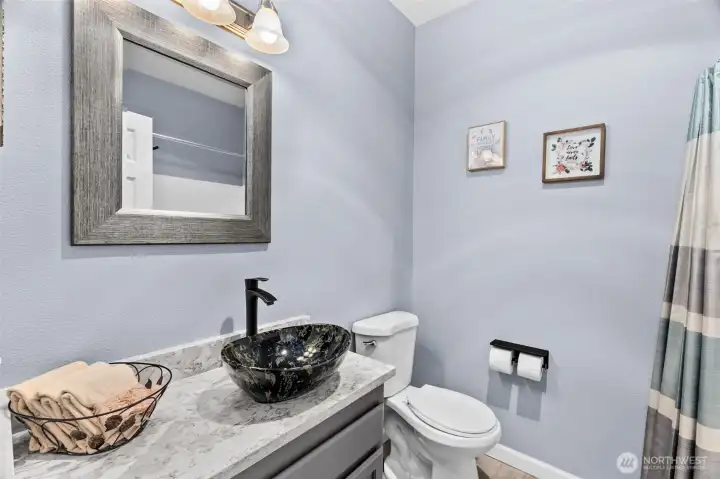 Updated 2nd bathroom with bath/shower combo with new rainfall shower head, pretty quartz vanity and new toilet.