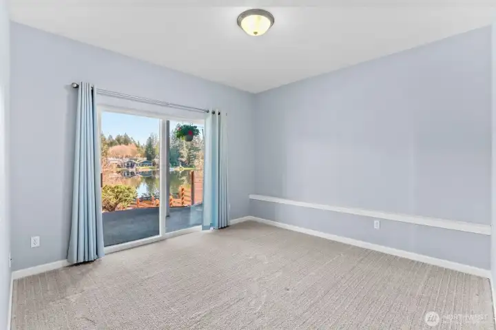 The spacious family room with plush carpeting and large slider to patio and lake beyond...