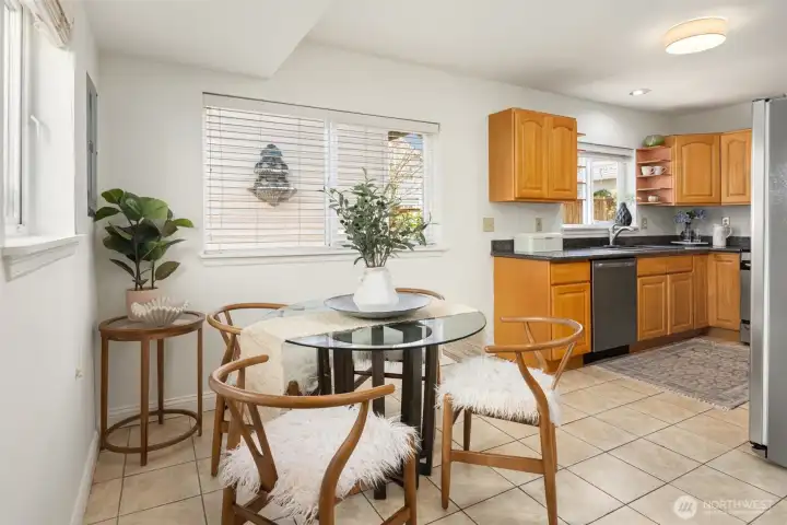 The main living and dining room flow into the kitchen and casual dining area with tiled floors.
