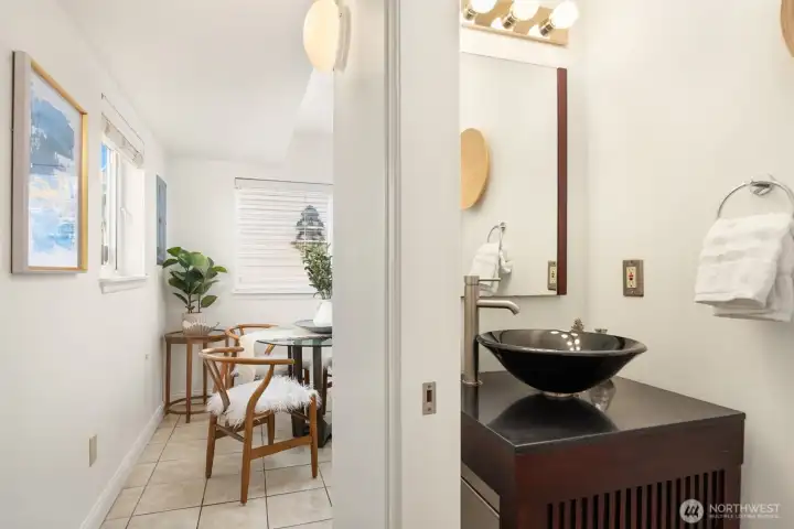 A discreetely located powder room is off the kitchen and side door leading to the back yard. A custom vanity with a vessel sink provides a classy ambiance.