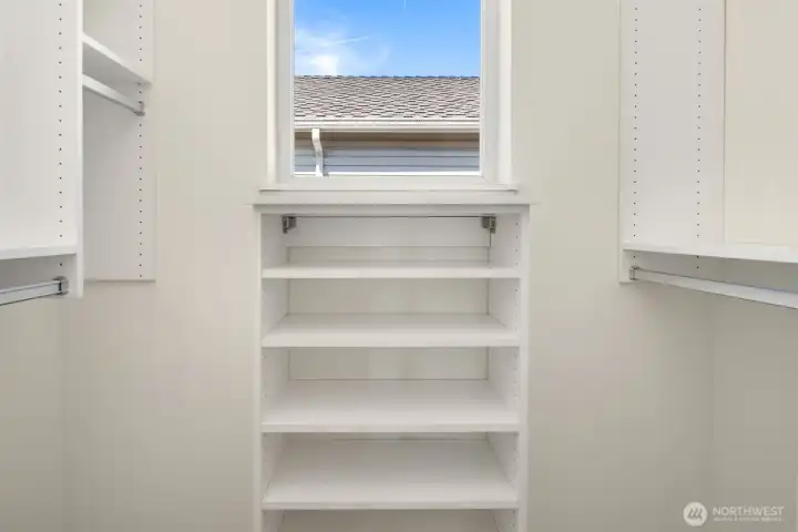 The oversized primary bedroom features this walk-in closet with custom organizers.