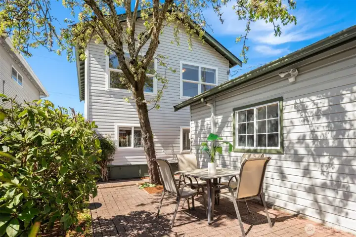 The backyard features a wonderfully private brick paver patio and lovely landscaping and is fully fenced.