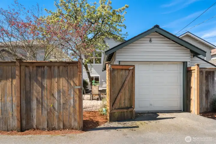 The garage features off a private paved alley with an automatic door opener.