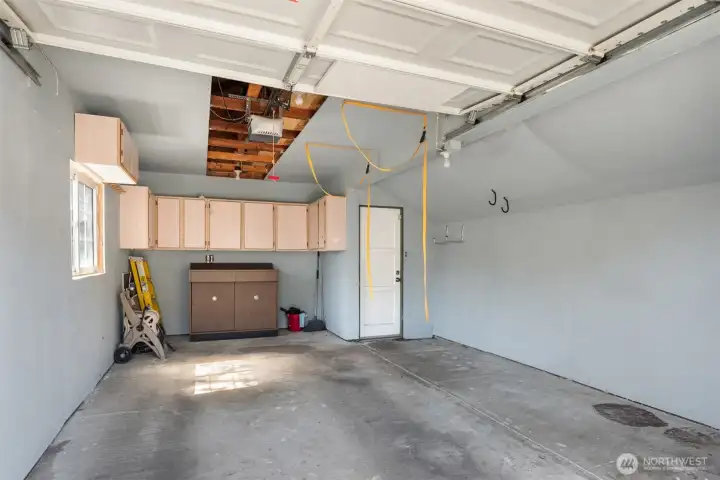 This is one spacious garage with plenty of room for your car, tools and storage. A man door on the left and another man door to the right lead to the backyard and house.