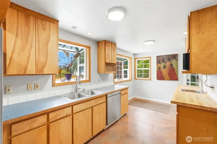 Kitchen sink and window out to deck and yard. Kitchen sink and window out to deck and yard.