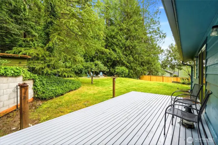 Private rear deck accessed from both primary bedroom and living room offering a quiet outdoor retreat. Private rear deck accessed from both primary bedroom and living room offering a quiet outdoor retreat.