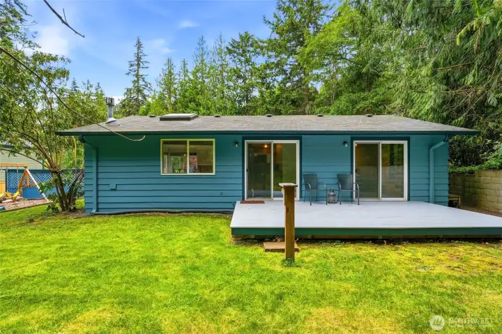Private back yard deck accessed from both primary bedroom and living room. Private back yard deck accessed from both primary bedroom and living room.