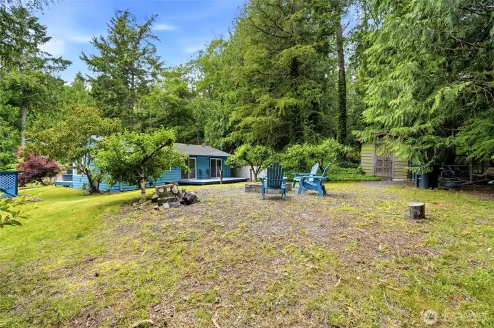 Secluded backyard with firepit, fruit trees, deck, play area for relaxed Whidbey Island living. Secluded backyard with firepit, fruit trees, deck, play area for relaxed Whidbey Island living.