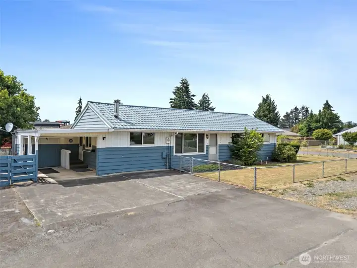 Appealing outside showcases tons of parking, flat yard with additional parking out front .