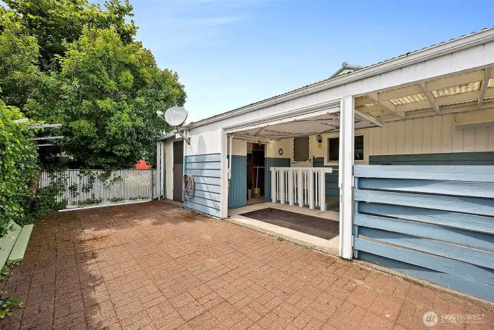 Nice private brick patio. You can see storage door at the back of the house as well as carport storage.