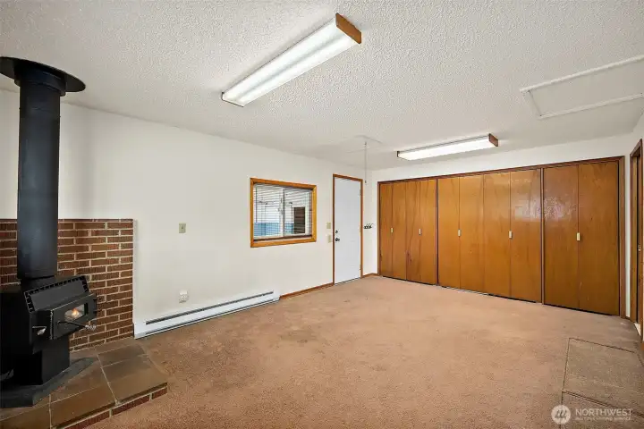 Entry from carport.  Cozy wood stove, wall to wall closet  with so much storage and function.