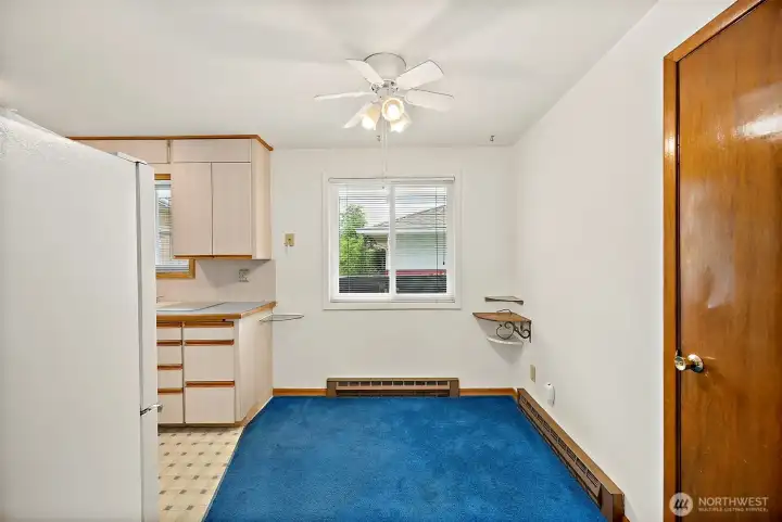 Nice dinning area with ceiling fan and large window for light.
