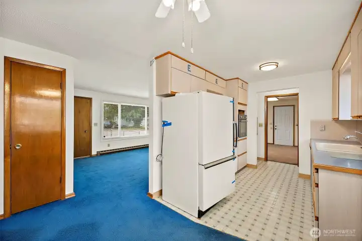 The kitchen leads to the dining area and into the living room. Very nice flow.