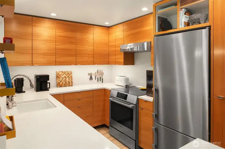 These gorgeous bookmatched hemlock cabinets are a showstopper. (Bookmatched cabinets feature mirror-image grain or pattern across adjoining cabinet doors or drawer fronts, resembling the pages of an opened book.)