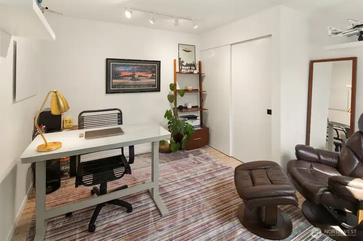 At the top of the stairs is the first bedroom which faces the front of the unit.