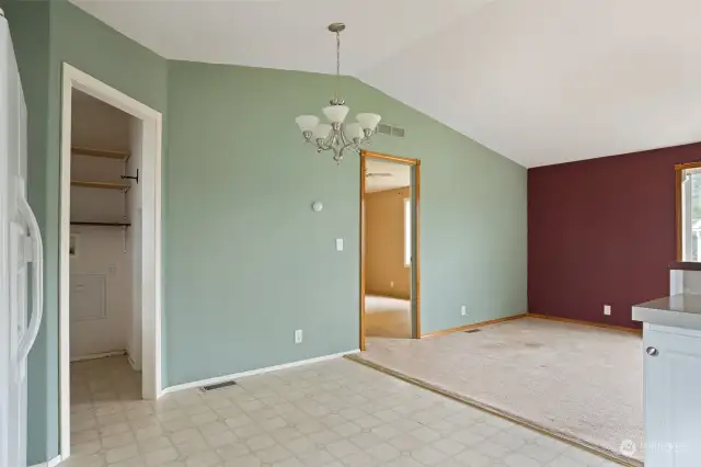 Dining area looking into laundry room and primary bedroom.