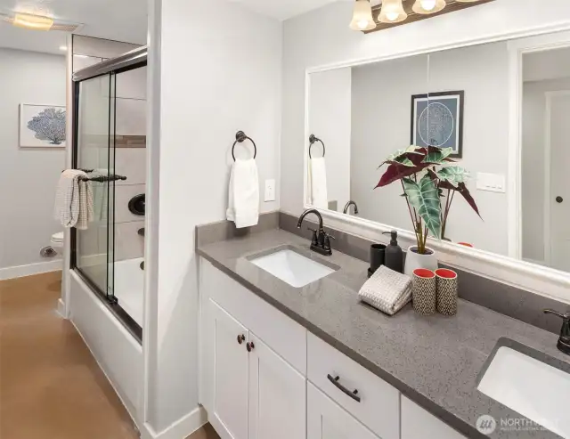 The lower level bathroom has dual sinks and a tub shower combo. Dreamy!