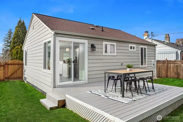 A gorgeous deck and tons of space to roam in this backyard!