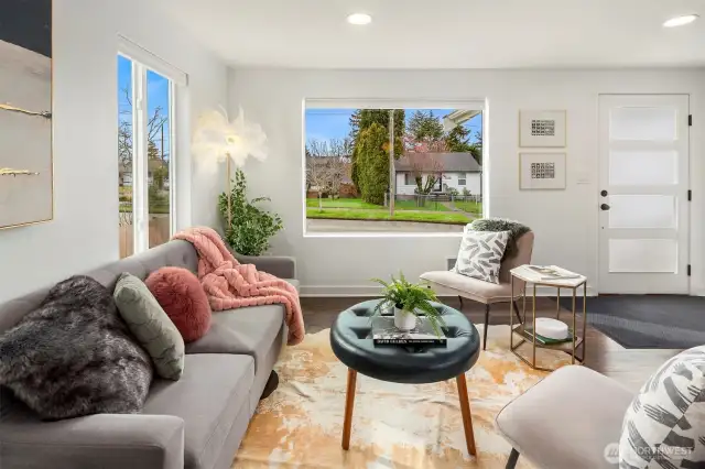 Looking from the kitchen to the living room, notice the gorgeous front door and light filled space.
