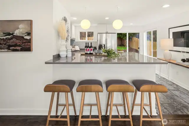 Stunning breakfast bar with quartz countertops.