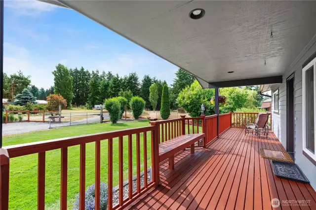 Covered front porch with room to sit, sip, and take in the view of the yard.