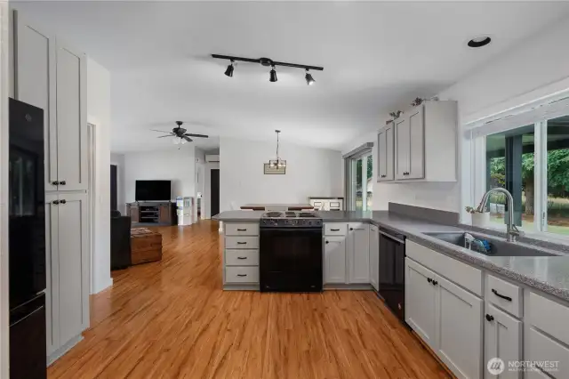 Modern open concept layout has plenty of counter space, storage space, natural light, and easy-to-maintain finishes.